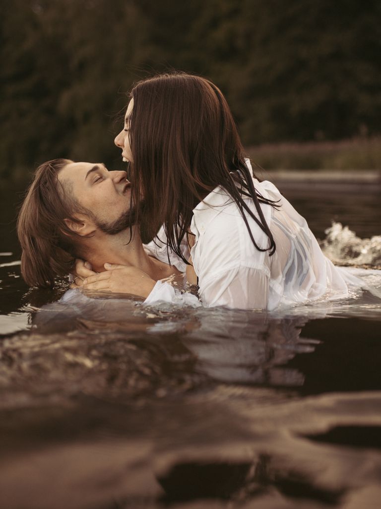 A loving couple in a close embrace in a serene lake setting, capturing a moment of romance and connection.